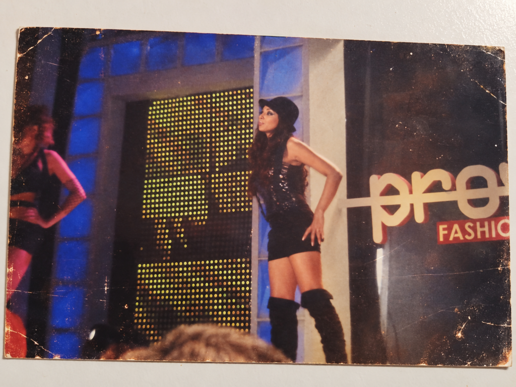 Woman on a brightly lit stage during a Bollywood fashion show in Mumbai.